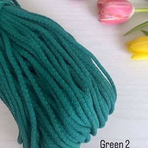 May include: A close-up of a deep green cotton cord, also known as macrame cord,  with the text "Green 2" visible in the image.
