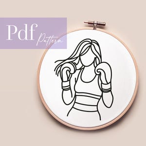 Könnte beinhalten: Ein Stickrahmen mit einer schwarzen Strichzeichnung einer Person mit Boxhandschuhen. Die Person trägt ein Tanktop. Der Text "Pdf Pattern" befindet sich in der oberen linken Ecke.