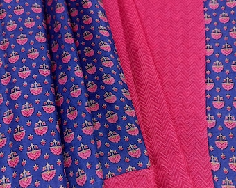 May include: A textile fabric featuring alternating panels of solid hot pink with a subtle chevron texture and deep blue sections decorated with a repeating pattern of small pink floral motifs and thin vertical lines in a light pink hue.