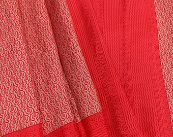 May include: A vibrant red fabric featuring a repeating pattern of light beige teardrop shapes. The textile includes distinct sections with vertical wavy lines and decorative borders, showcasing a consistent color palette of bright red and soft beige.