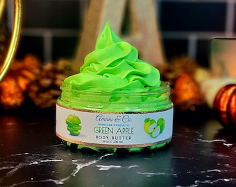 May include: A green apple scented body butter in a clear jar with a white label that reads "Amani & Co. Skincare Products Green Apple Body Butter 8 oz | 236 ml".