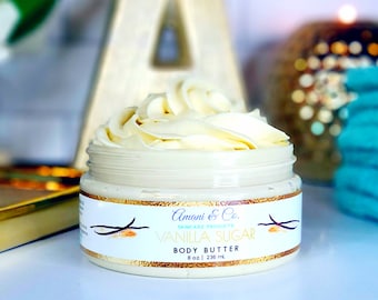 May include: A white jar of vanilla sugar body butter with a gold lid. The jar is labeled "Amani & Co. Skincare Products Vanilla Sugar Body Butter 8 oz | 236 ml."