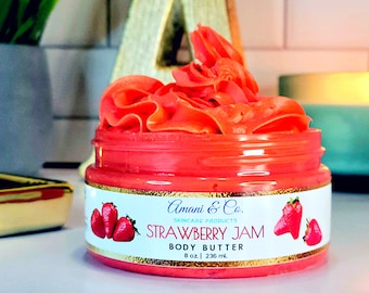 May include: A jar of strawberry jam body butter with a pink lid and a white label that says "Amani & Co. Skincare Products Strawberry Jam Body Butter 8 oz | 236 ml".
