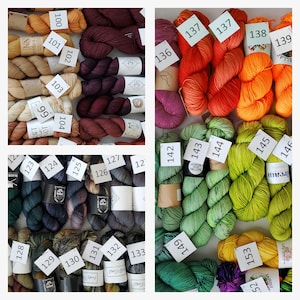 May include: A collection of yarn skeins in various colors, including red, orange, green, blue, and brown. The skeins are labeled with numbers from 99 to 153.
