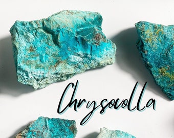 May include: A collection of raw chrysocolla stones, featuring a vibrant blue-green color with brown and white markings. The stones are irregularly shaped and have a rough, natural texture. The word "Chrysocolla" is written in black cursive lettering.