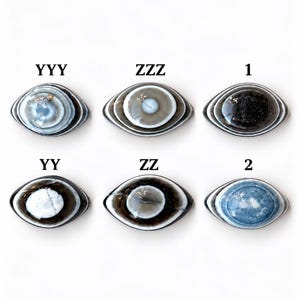 May include: Six oval-shaped stones arranged in two rows, each featuring concentric bands of colour resembling an eye. Labels YYY, ZZZ, 1, YY, ZZ, and 2 are positioned above each stone. The stones display varied shades of blue, grey, white, and black.