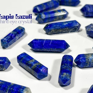 May include: A collection of lapis lazuli crystal points, also known as "third eye crystals", in various sizes and shapes. The crystals are a deep blue colour with flecks of gold pyrite.