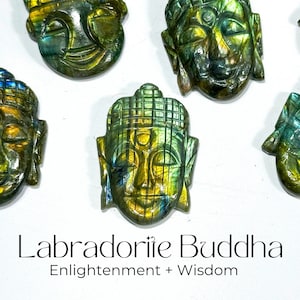 May include: A collection of five Labradorite Buddha carvings, each with a unique green, blue, and gold color pattern. The carvings are all in the same style, with a serene expression and a third eye on the forehead. The text "Labradorite Buddha Enlightenment + Wisdom" is displayed below the carvings.