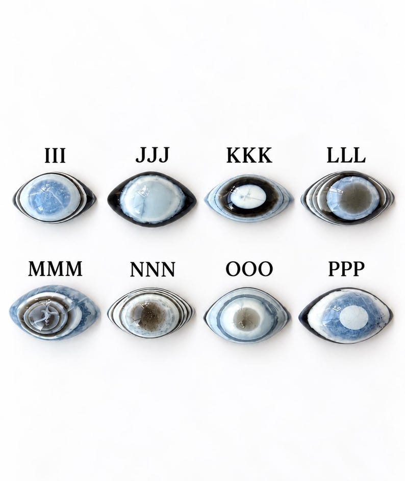 May include: Eight oval-shaped cabochons arranged in two rows, each featuring concentric eye-like patterns in shades of blue, grey, white, and black. Each stone is labelled with letters III, JJJ, KKK, LLL, MMM, NNN, OOO, and PPP above it.