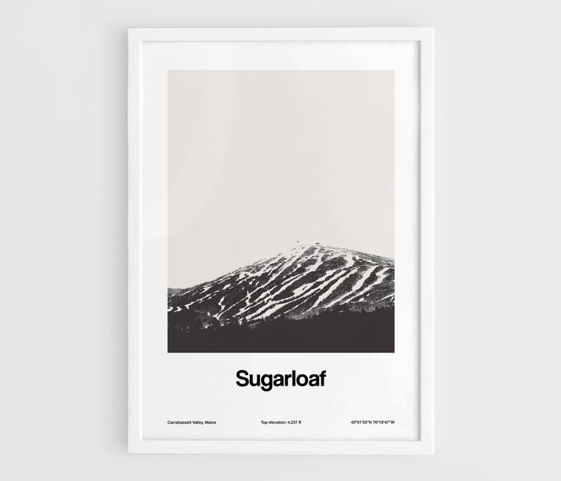 May include: A black and white photograph of Sugarloaf Mountain in Carrabassett Valley, Maine. The mountain is covered in snow and has ski runs visible. The text "Sugarloaf" is printed below the image, along with the mountain's top elevation and coordinates.