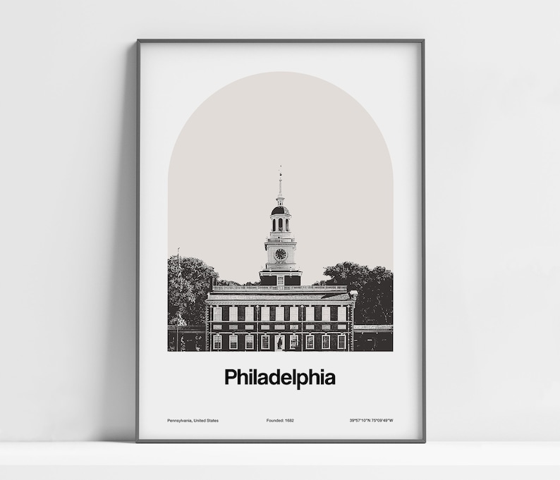 May include: A black and white illustration of Independence Hall in Philadelphia, Pennsylvania. The building has a tall clock tower and is surrounded by trees. The text "Philadelphia" is below the building, along with the city's founding date and coordinates.