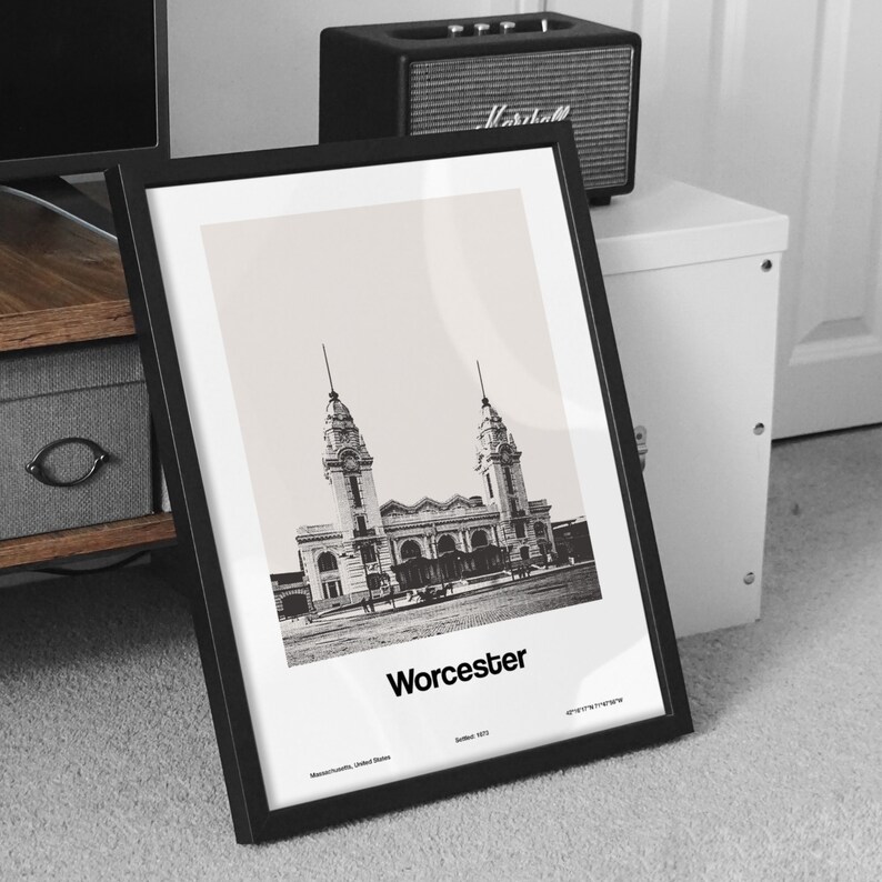 May include: Black and white photo print of the Worcester Union Station in Worcester, Massachusetts. The print is framed in a black frame and has the text "Worcester" printed below the image.