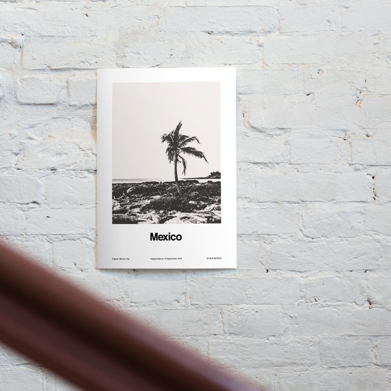 May include: Black and white minimalist poster with a palm tree silhouette on a beach. The poster has the word "Mexico" printed at the bottom and the text "Capital: Mexico City, Independence: 16 September 1810".