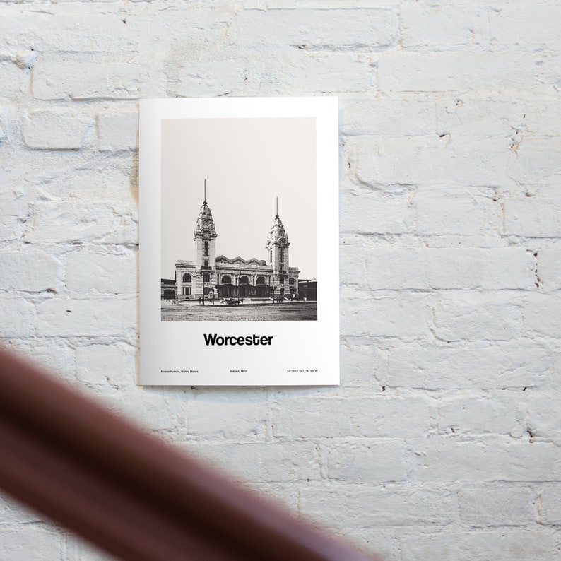 May include: Black and white photograph of a historic train station building with two towers. The building is labeled "Worcester" in the bottom center of the image.