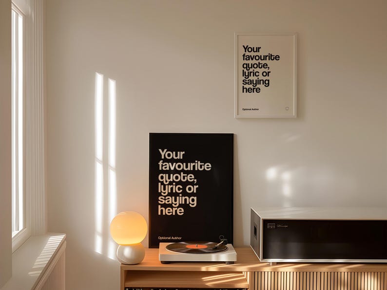 May include: An interior shot showing two framed prints with the text "Your favourite quote, lyric or saying here." A record player, a spherical lamp, and a stereo are on a wooden cabinet. The room is illuminated by sunlight.