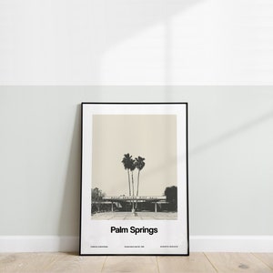 May include: Black and white photograph of Palm Springs City Hall with palm trees in the foreground. The text "Palm Springs" is printed below the image.