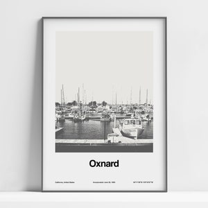 May include: A black and white photograph of a harbor with boats docked. The text "Oxnard" is printed below the image, along with the city's location, incorporation date, and coordinates.