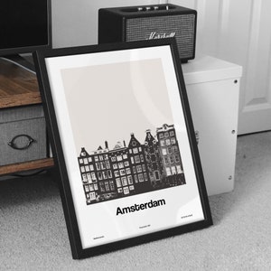 May include: Black and white print of a cityscape with the word "Amsterdam" printed below. The print is framed in a black frame.