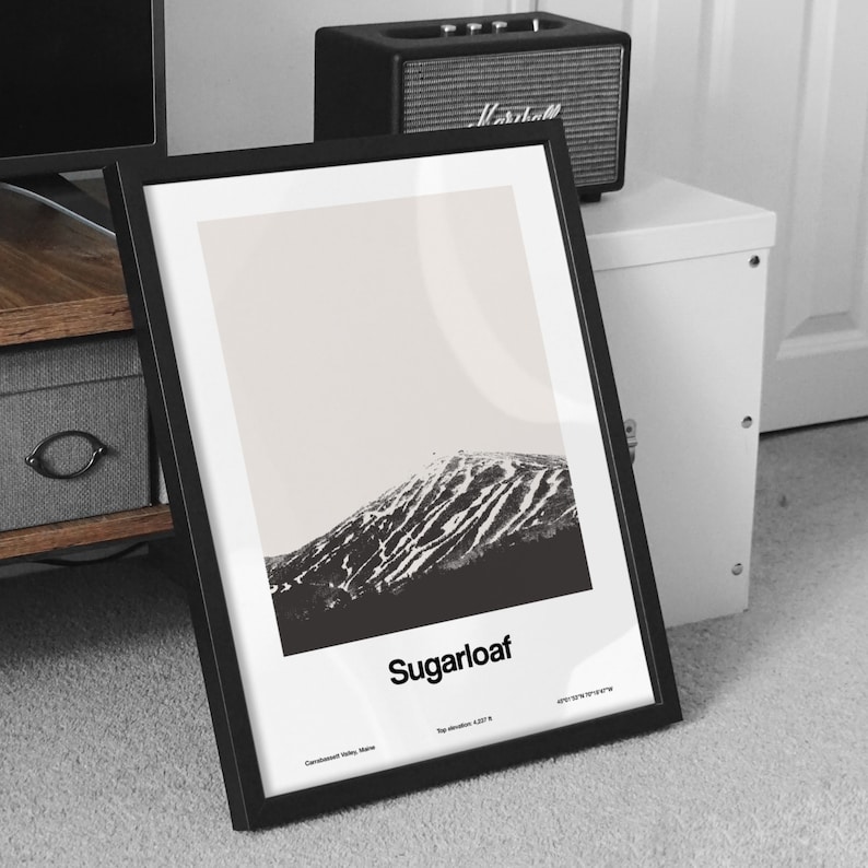 May include: Black and white framed print of Sugarloaf Mountain in Connecticut. The print has the text "Sugarloaf" and "Top elevation 4,207 ft" at the bottom.