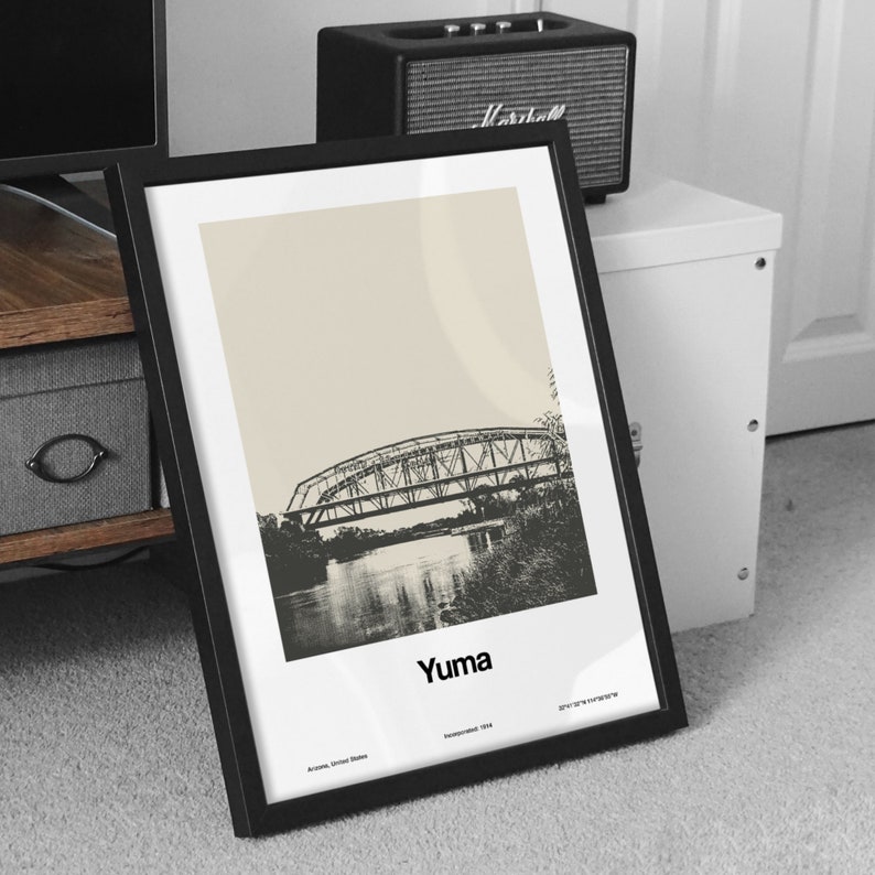 May include: Black and white framed print of a bridge over a river with the text "Yuma, Arizona, United States, Incorporated 1874" at the bottom.
