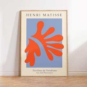 May include: A framed art print featuring a red abstract shape on a blue background. The print is titled "Pavillon de Vend&ocirc;me Aix En Provence" and is attributed to Henri Matisse.