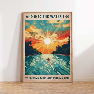 May include: A vintage-style poster with a colorful sunset scene over a body of water. The text reads "And into the water I go to lose my mind and find my soul."