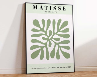 May include: A green and white art print featuring a Matisse cut-out design. The print has a black frame and includes the text "MATISSE THE CUT-OUTS" and "My curves are not crazy: Henri Matisse, Jazz, 1947".
