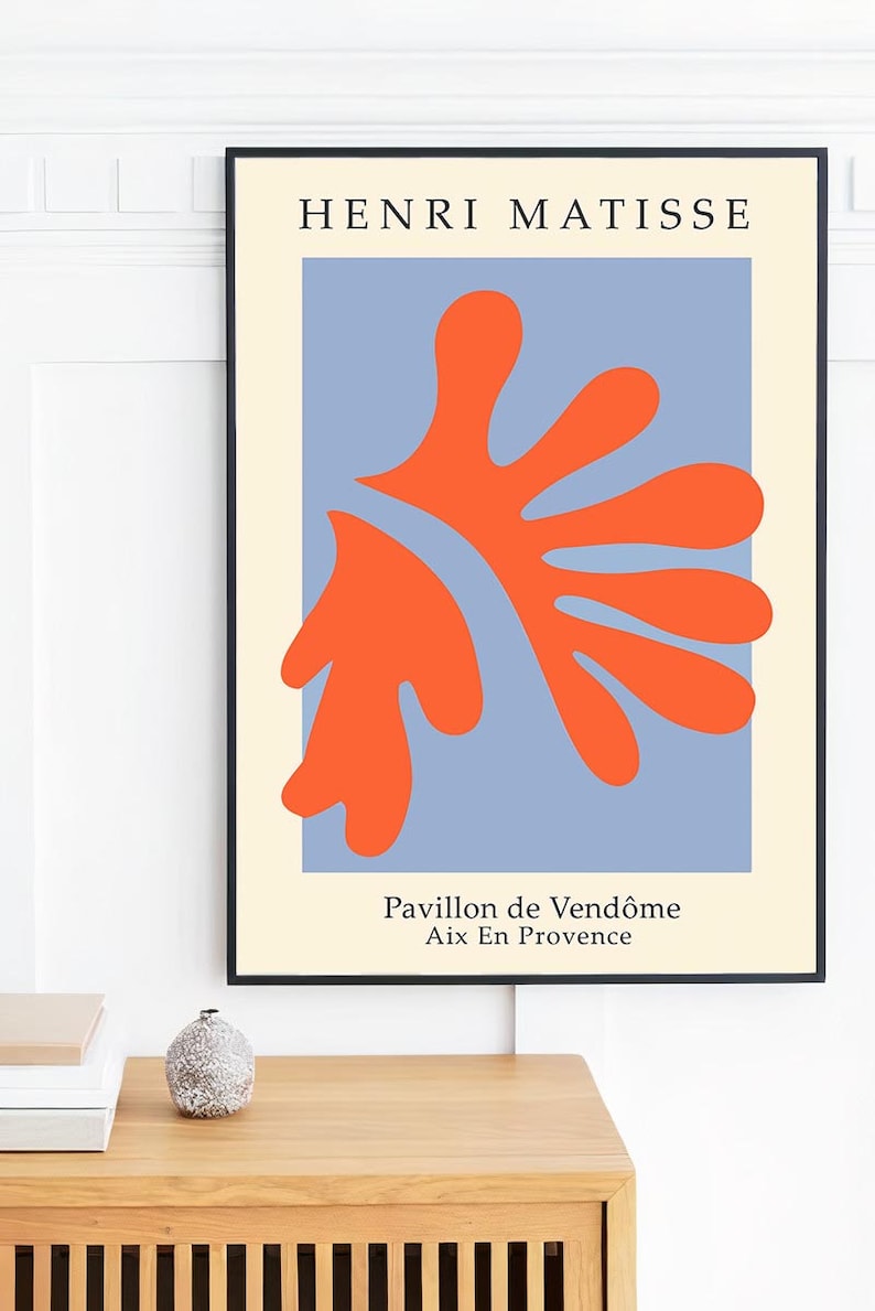 May include: A framed print of a Matisse painting titled "Pavillon de Vend&ocirc;me Aix En Provence". The painting features a large, abstract orange shape on a blue background.