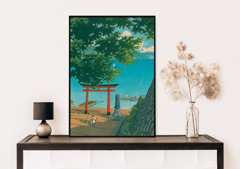 May include: A vintage Japanese woodblock print depicting a red torii gate, a stone statue, and a view of a blue lake with a small boat. The scene is framed by lush green trees and a stone wall.