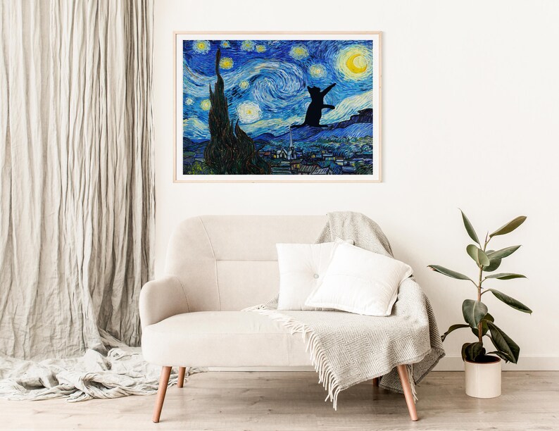 May include: A framed print of a black cat silhouette jumping in front of a starry night sky, reminiscent of Vincent van Gogh's 'Starry Night'. The cat is facing the viewer and appears to be reaching for a crescent moon.
