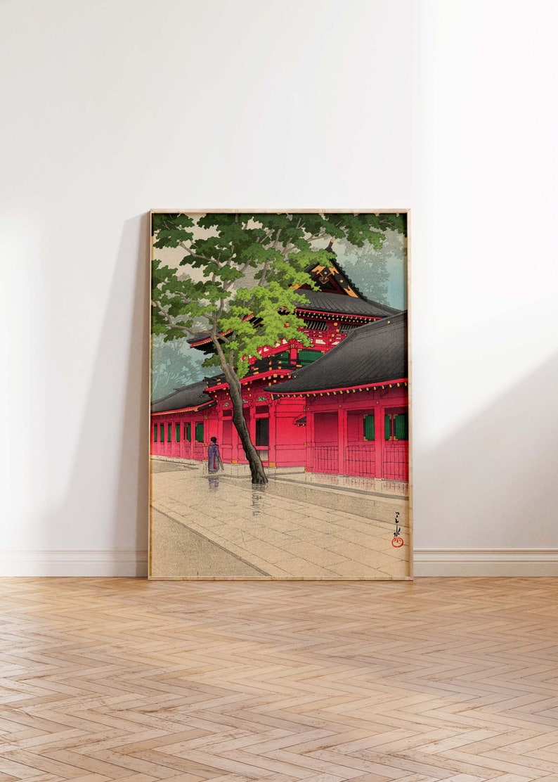 May include: A traditional Japanese woodblock print depicting a red temple with a black roof and a green tree in the foreground. A single figure walks along a stone path in front of the temple.