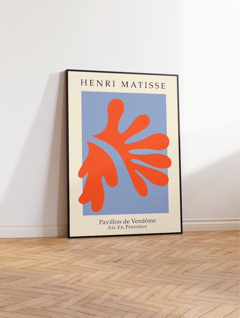 May include: A framed print of a painting by Henri Matisse titled "Pavillon de Vend&ocirc;me Aix En Provence". The painting features a large, orange-red abstract shape on a light blue background.