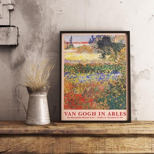 May include: A vintage poster for the exhibition "Van Gogh in Arles" at the Metropolitan Museum of Art. The poster features a painting of a field of flowers in various shades of red, yellow, blue, and green. The text "Van Gogh in Arles" is printed in red at the bottom of the poster.