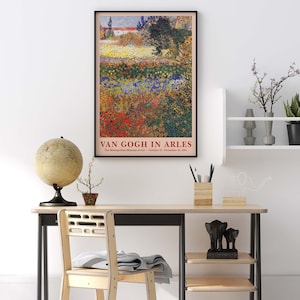 May include: A vintage poster for a Van Gogh exhibit at the Metropolitan Museum of Art. The poster features a painting of a field of flowers in various shades of red, yellow, blue, and green. The text on the poster reads "Van Gogh in Arles" and includes the dates of the exhibit.
