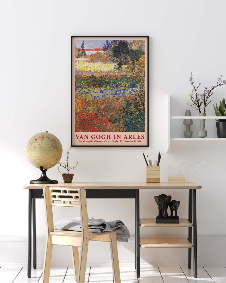 May include: A vintage poster for a Van Gogh exhibit at the Metropolitan Museum of Art. The poster features a painting of a field of flowers in various shades of red, yellow, blue, and green. The text on the poster reads "Van Gogh in Arles" and includes the dates of the exhibit.
