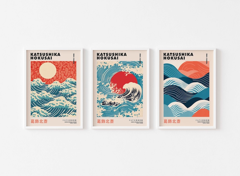 May include: Three framed prints of Japanese woodblock prints by Katsushika Hokusai, featuring the Great Wave off Kanagawa, with a red sun and blue and white waves. The text on the prints reads "Katsushika Hokusai" and "葛飾北斎".