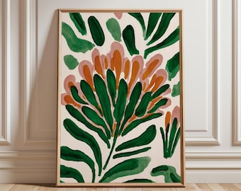 May include: A framed botanical art print featuring a stylized floral design. The artwork showcases a central flower with green, orange, and pink elements against a cream background. The frame is a warm, natural wood tone, enhancing the artwork's aesthetic.