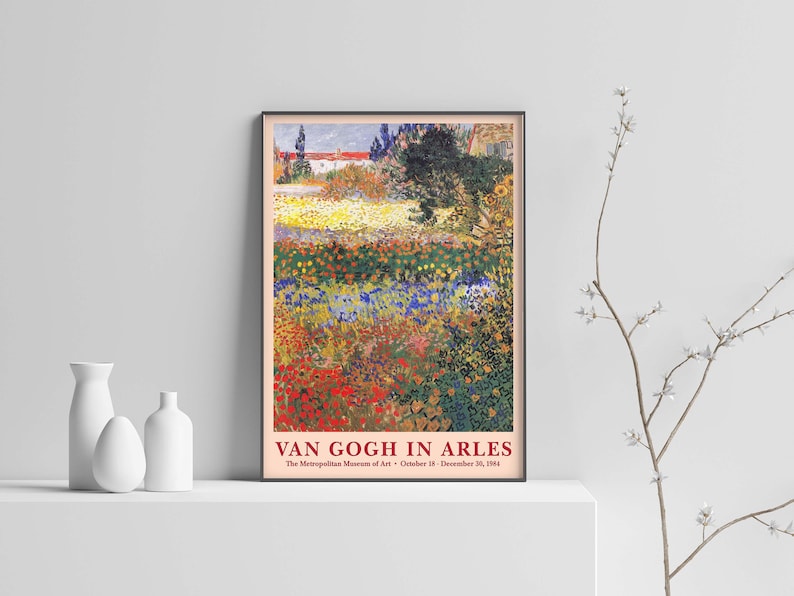 May include: A vintage poster advertising an exhibition of Van Gogh's work in Arles at the Metropolitan Museum of Art. The poster features a painting of a field of colorful flowers with a house in the background. The text on the poster reads "Van Gogh in Arles" and "The Metropolitan Museum of Art - October 18 - December 30, 2004."