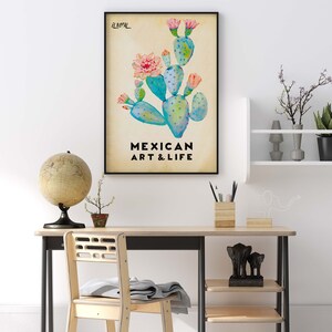 May include: A framed print with a watercolor illustration of a prickly pear cactus with pink flowers. The text "EL NOPAL" and "MEXICAN ART & LIFE" is printed below the illustration.