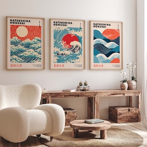 May include: Three framed prints of Japanese woodblock prints depicting waves and a red sun. The prints are titled "Katsushika Hokusai" and "葛飾北斎".