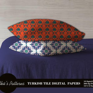 May include: Two decorative pillows with Turkish tile patterns. One pillow has an orange background with teal and green floral designs. The other pillow has a white background with purple, teal, and green floral designs. The pillows are 12 x 12 inches.