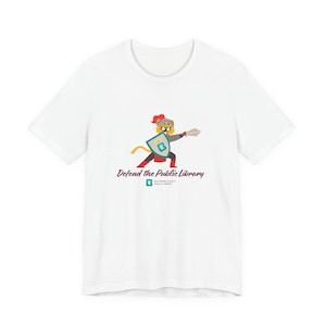 May include: A white short-sleeve t-shirt featuring a graphic of a cartoon tiger wearing a knight's helmet, holding a sword and a shield with a letter B. Below the graphic is the text Defend the Public Library and a Baltimore County Public Library logo.