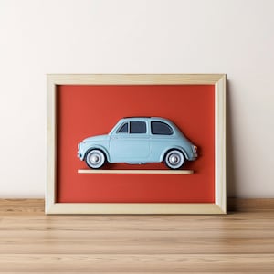 May include: A framed picture of a light blue vintage car on a red background.