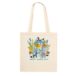 May include: A cream-coloured tote bag featuring a vibrant illustration of animals and buildings. The design includes a giraffe, lion, elephant, and zebra, with the text "HAPPY EARTH DAY!" printed below the image.