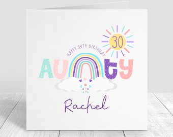 May include: A colourful birthday card featuring a rainbow, a sun with the number 30 inside, and the word "Aunty" in rainbow colours. The name "Rachel" is written in purple below the rainbow. The card reads "Happy 30th Birthday".