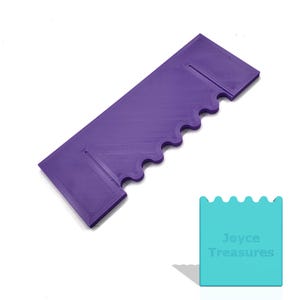 May include: A purple, rectangular tool with a wavy edge and two rectangular cutouts. The tool is made of a solid material and has a ridged texture. A teal square with the text "Joyce Treasures" is in the lower right corner.