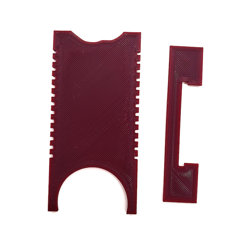 May include: A red plastic tool with a comb-like edge and a cutout in the middle. The tool is designed to help remove SIM cards from phones.