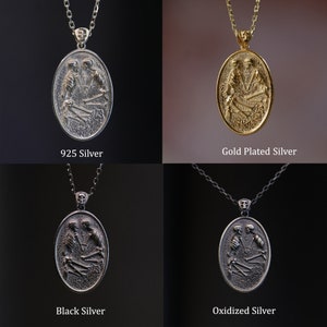 May include: Four silver pendants with a design of two skeletons embracing. The pendants are shown on chains in four different finishes: 925 Silver, Gold Plated Silver, Black Silver, and Oxidized Silver.