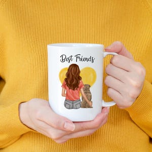 May include: White ceramic mug with the words "Best Friends" in black script. The mug features an illustration of a person with brown hair and a dog, with yellow heart-shaped balloons in the background.