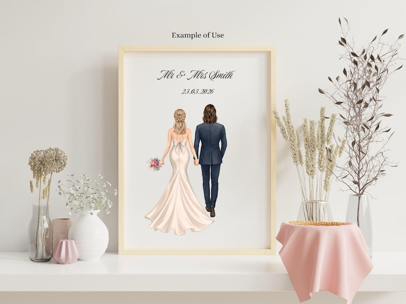 May include: A framed print featuring a back view of a couple holding hands, with the bride in a white gown and the groom in a dark suit. The text "Mr & Mrs Smith" and the date "23.03.2026" are printed in black above the figures on a white background.